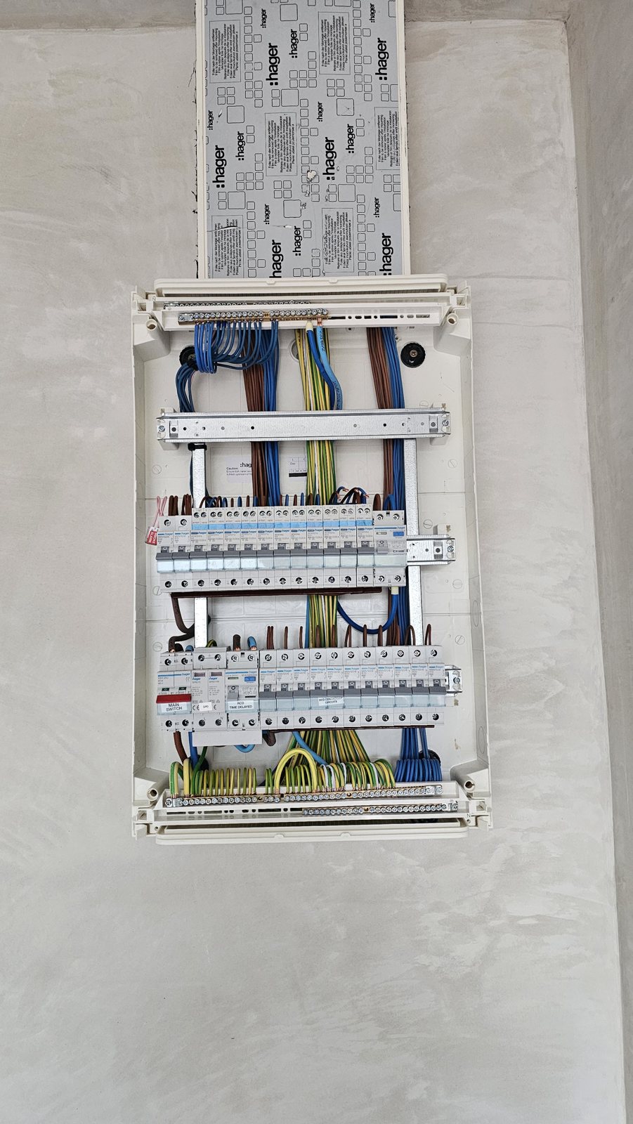 A consumer unit being wired, cables dressed into the breakers